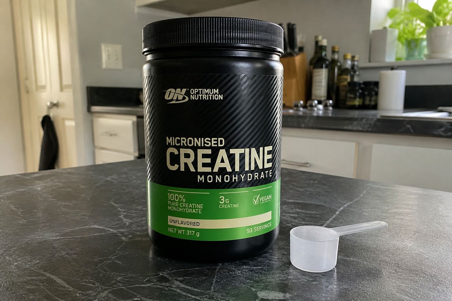 A labelled creatine tub and scoop.